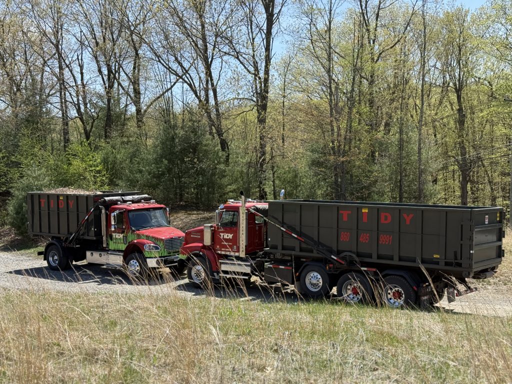 A Tidy Services dumpster truck used for debris and waste removal around Burlington, CT