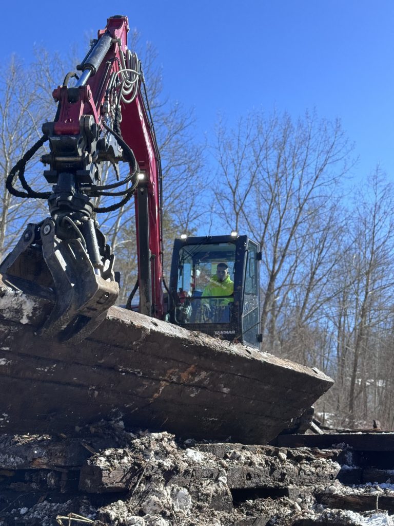 Forestry Services: Excavator operated by Tidy Services grabbing debris.